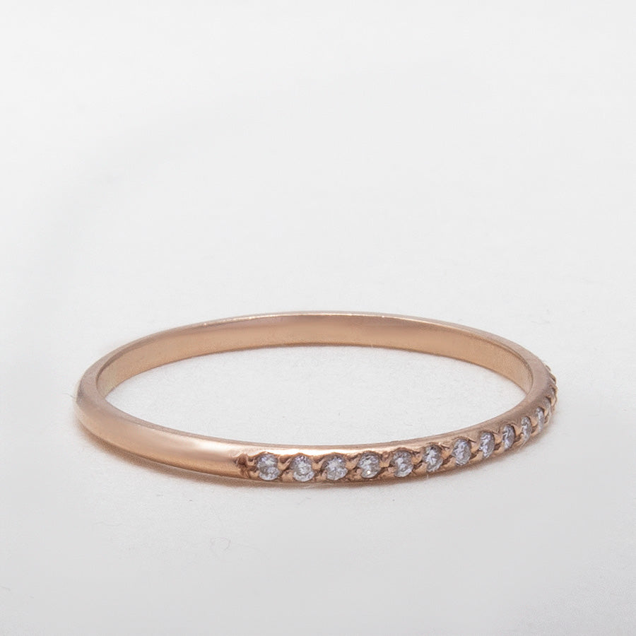 Close-up of 14K gold half eternity band with sparkling moissanites