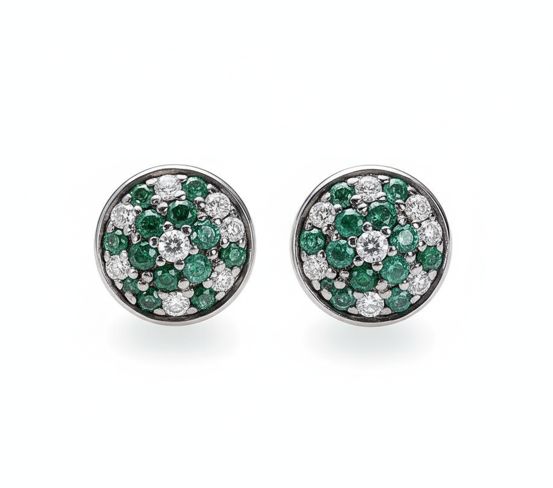 Pair of round earrings with green gemstones and clear stones on a white background