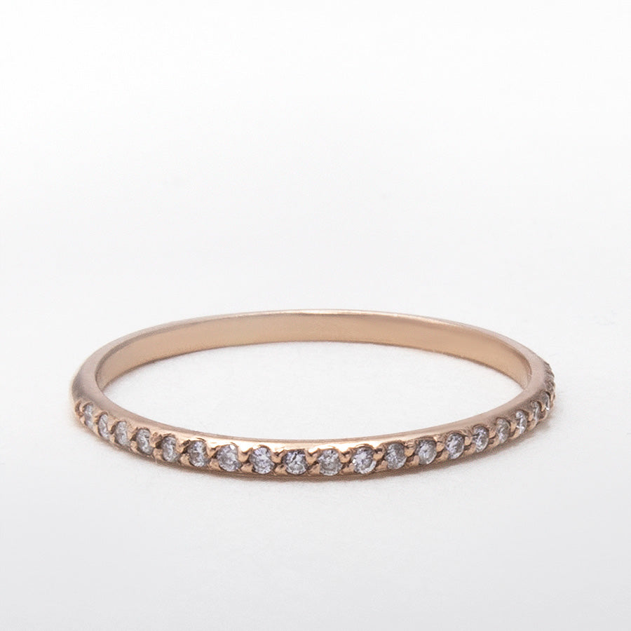 Moissanite half eternity ring in solid 14K gold on white background