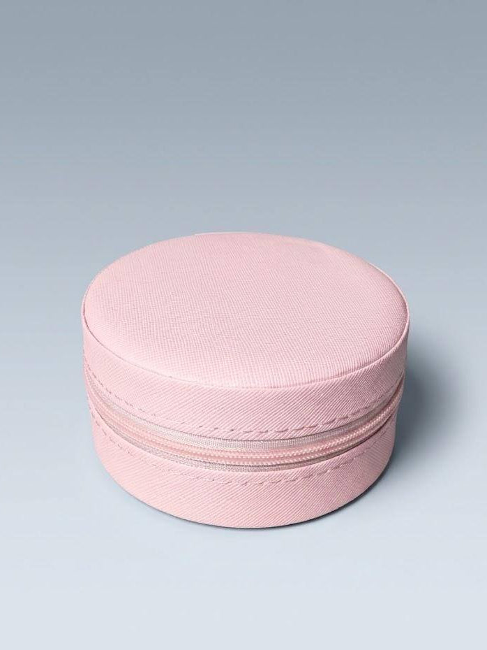 Pink round jewelry box on a light gray background