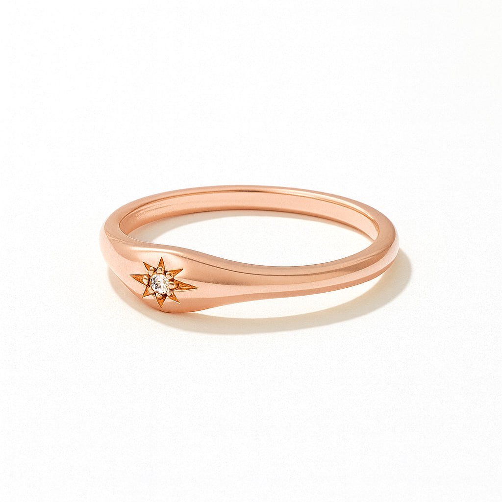 Rose Gold Star Engraved Diamond Ring with a small diamond on a white background