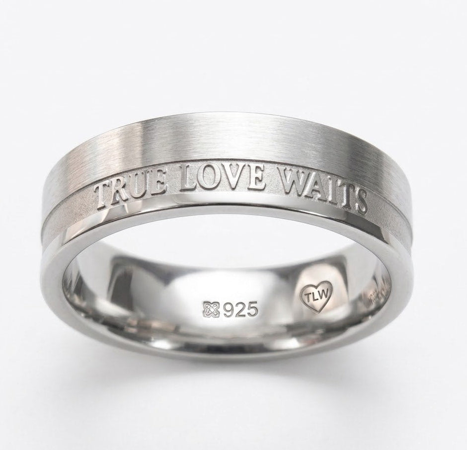 Silver ring with 'True Love Waits' engraving on a white background