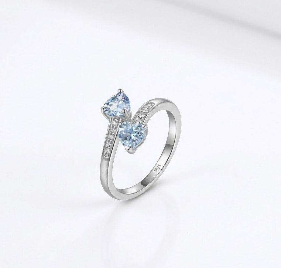 Silver ring with a blue gemstone on a white background