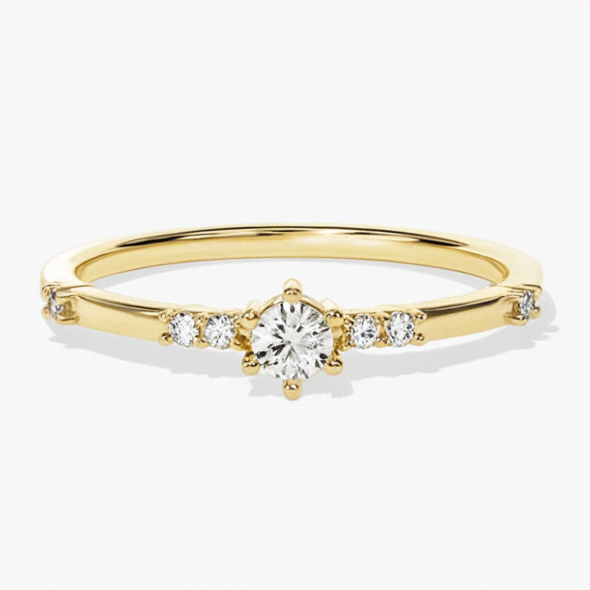 moissanite promise ring in 14K gold on white background