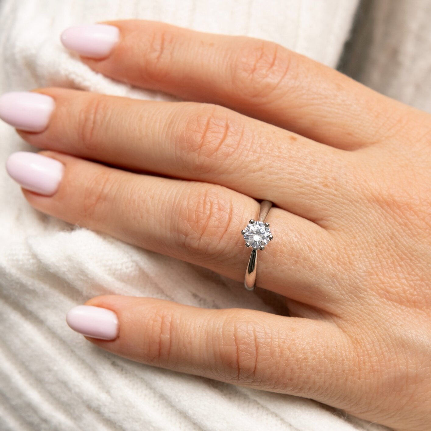 0,5-Carat LAB Diamond Engagement Ring on hand, featuring 14K solid white gold band and round cut diamond centerpiece.