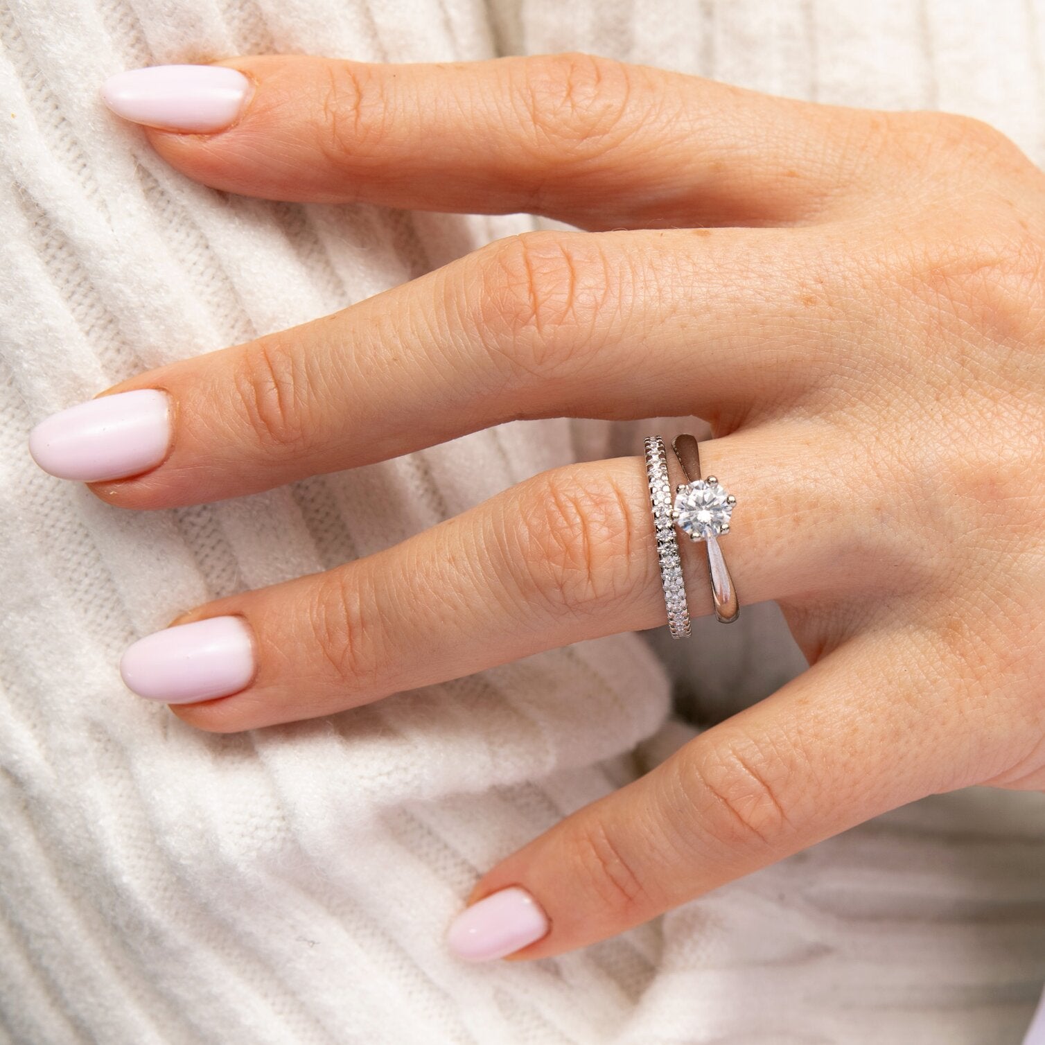 0,5-Carat LAB Diamond Engagement Ring on hand with polished nails, elegant round cut diamond in white gold band.