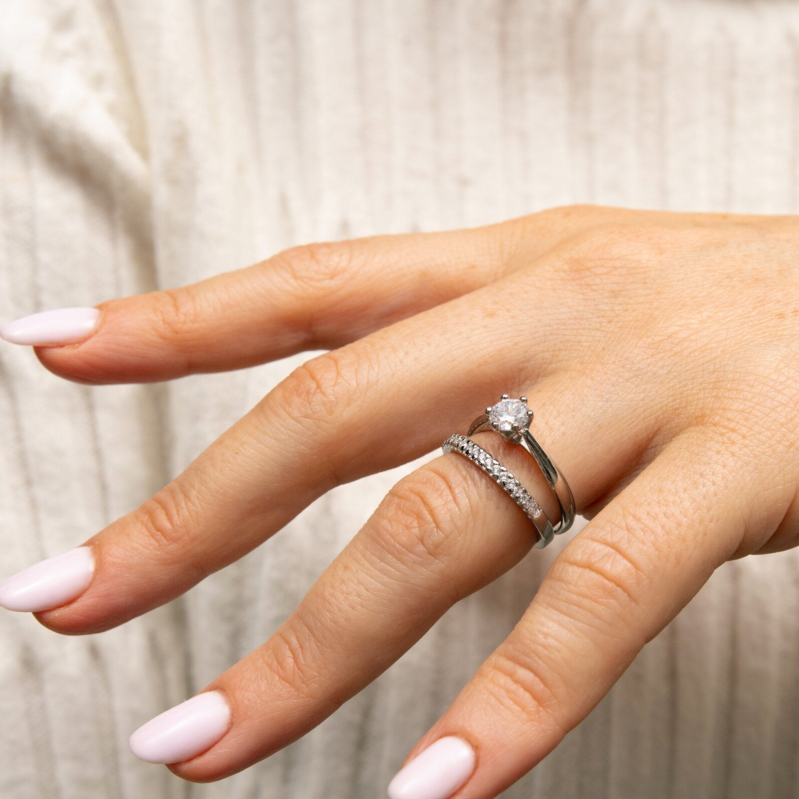 0,5-Carat LAB Diamond Engagement Ring on hand with a white gold band and round cut diamond centerpiece.
