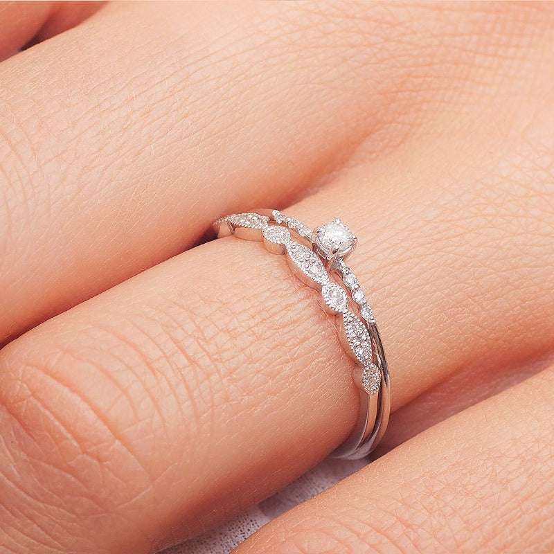 Dainty white gold ring worn on female hand