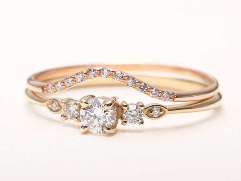 Stackable promise ring paired with matching gold bands