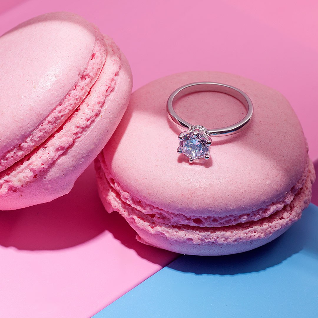 2-carat diamond engagement ring made 14K white gold on pink and blue background with macaroons