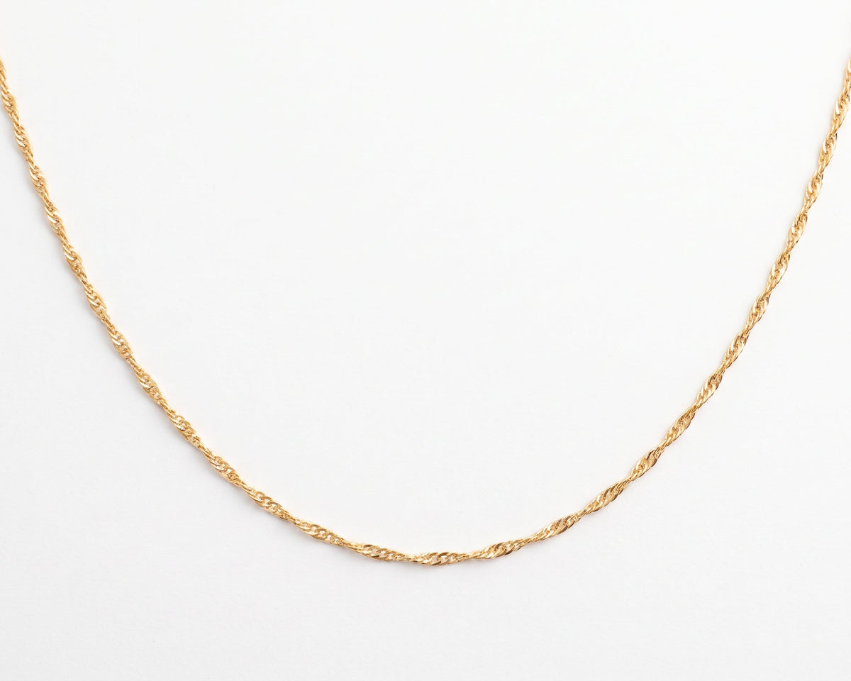 A delicate Dainty Gold Singapore Chain Necklace with a twisted rope texture, displayed in a U-shape against a clean white background.
