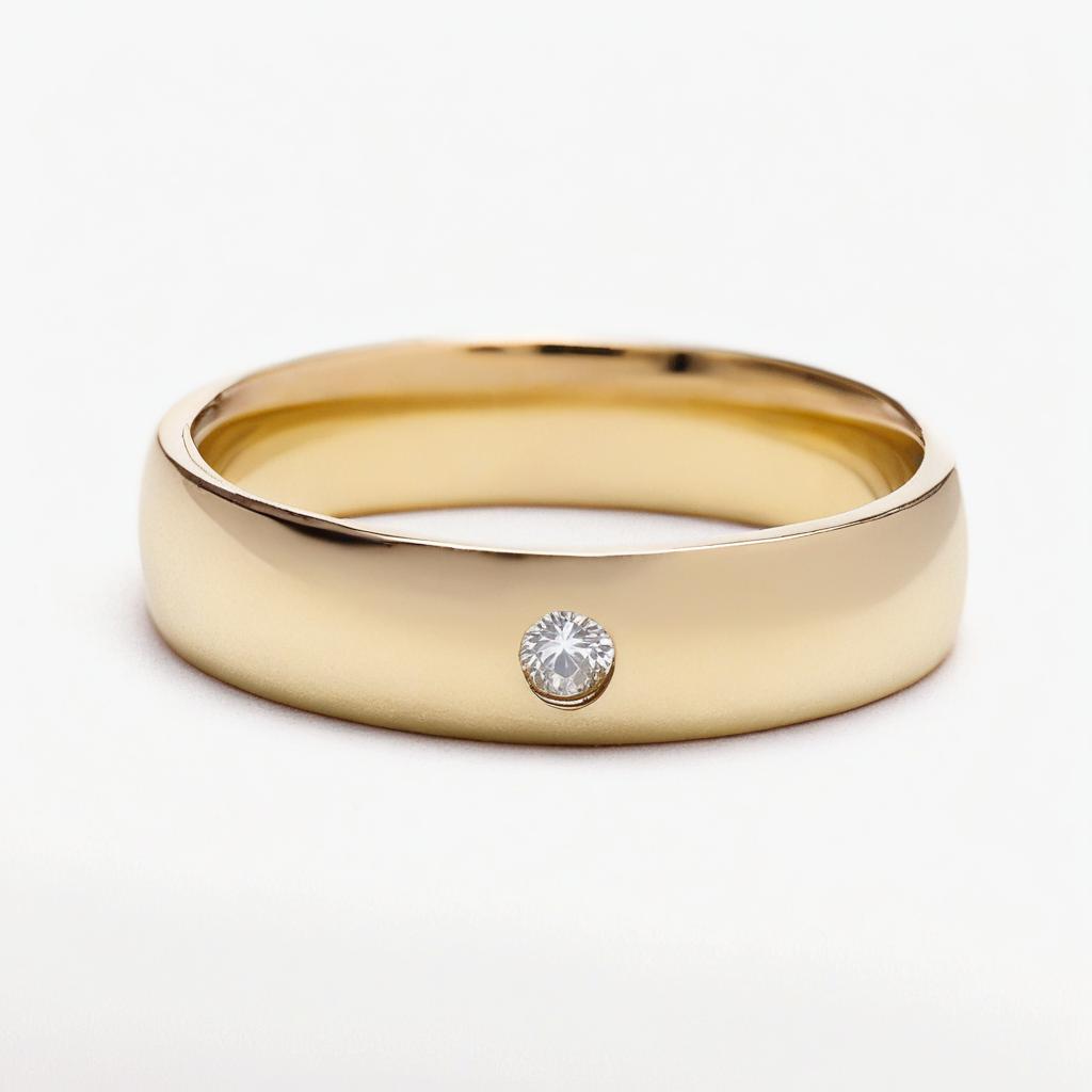 Of a gold ring with a single diamond in the center. the ring appears to be made of a smooth, polished gold material and has a simple, minimalist design. the diamond is round and clear, and it is set in a simple prong setting. the band of the ring is thin and thin, and the overall color of the gold is a warm, golden hue. the background is plain white, making the ring stand out.