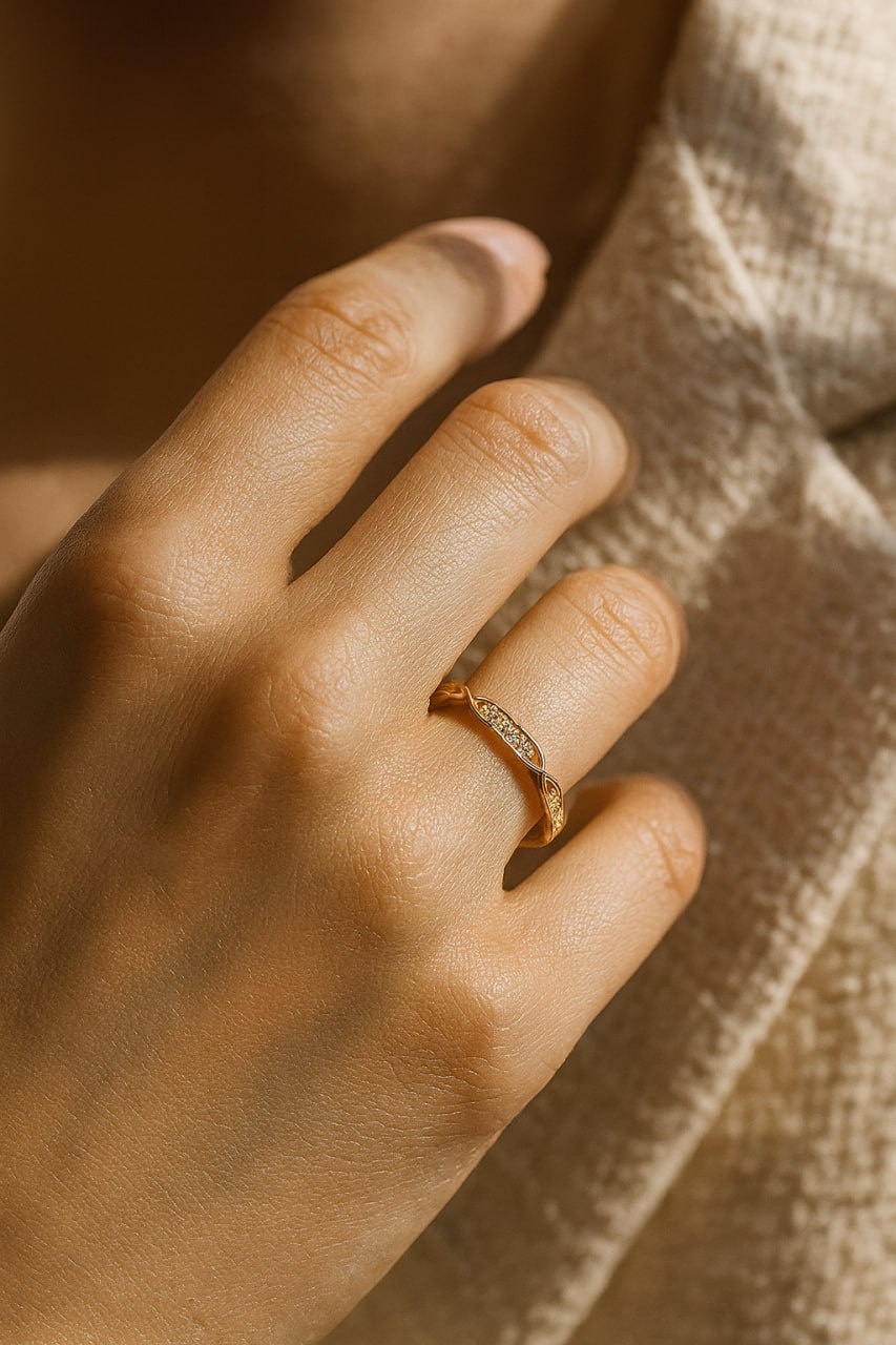 Close-up of a hand wearing a Classic Yellow Gold Eternity Wedding  with a blurred background