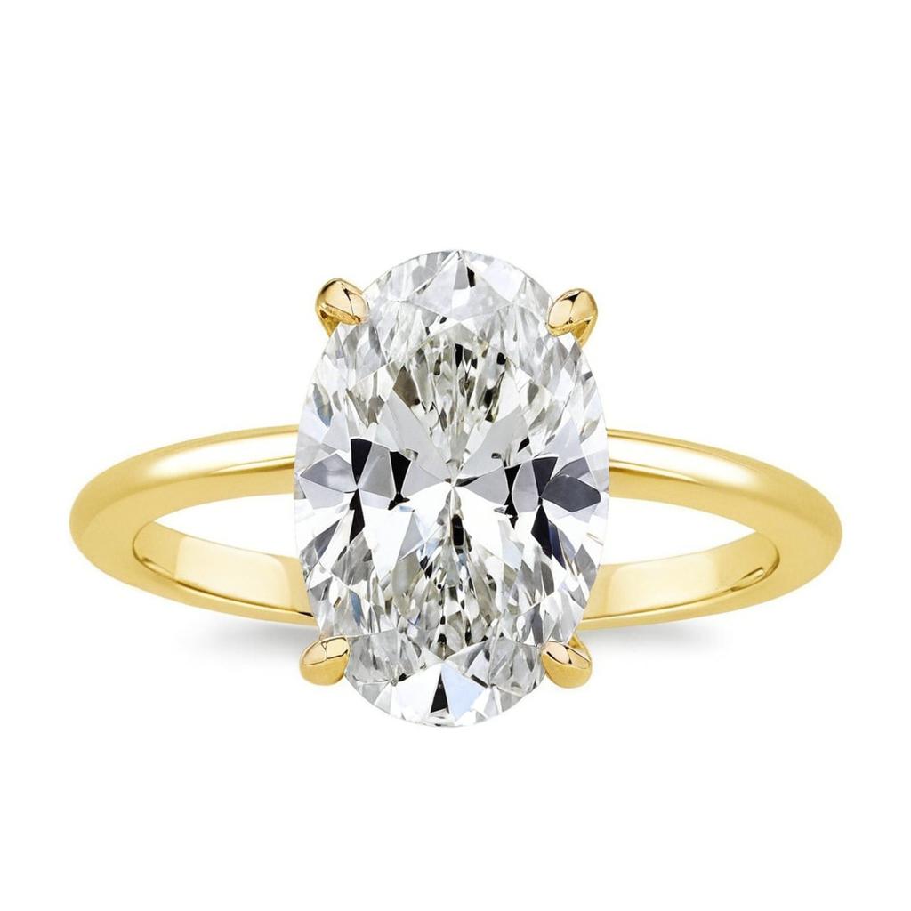 Close-up of oval moissanite engagement ring with 3.5 carat center stone and halo setting-yellow gold