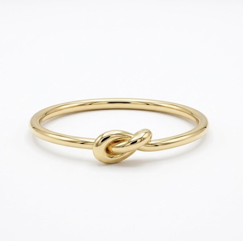 Gold-plated silver knot ring on a white background