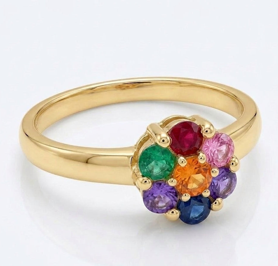 A yellow gold plated silver ring with a flower-shaped cluster of seven round-cut gemstones in rainbow colors, set against a clean white background.