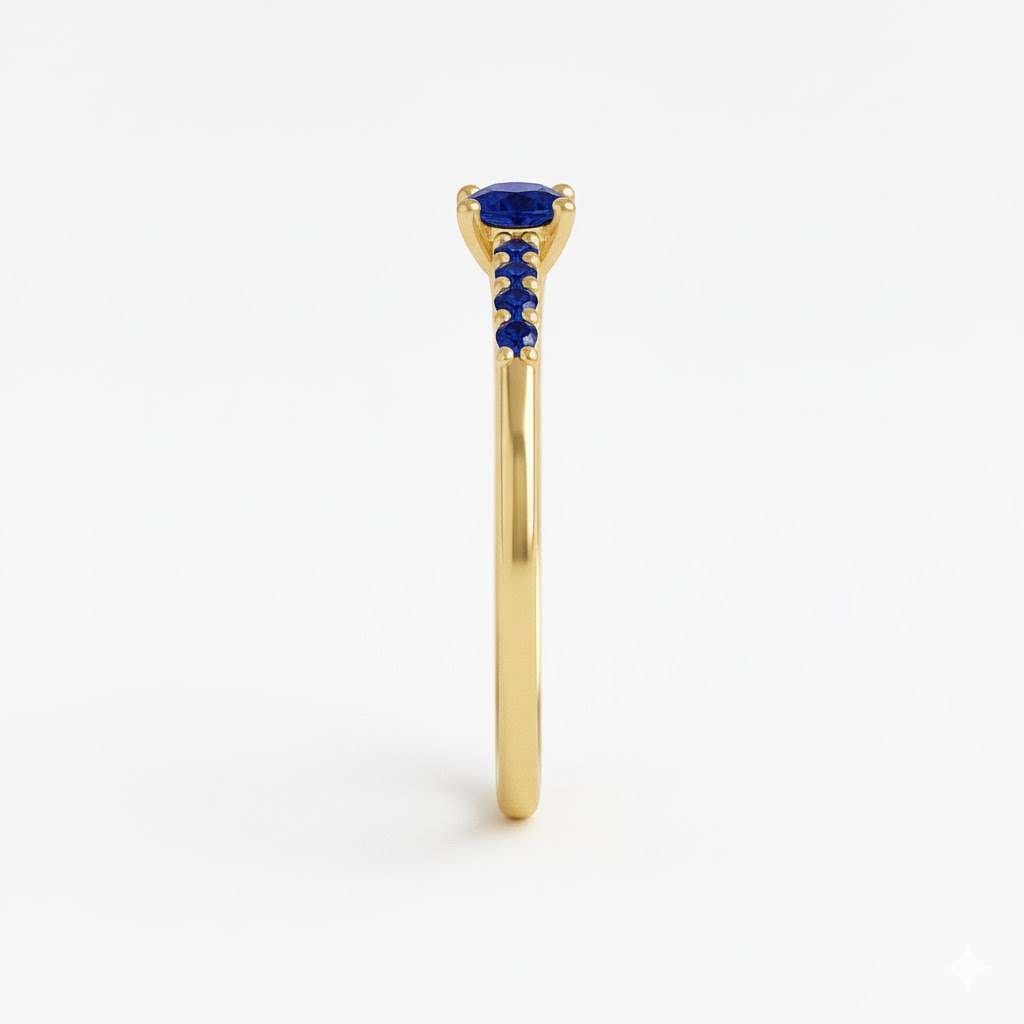 Gold ring with a blue gemstone on a white background