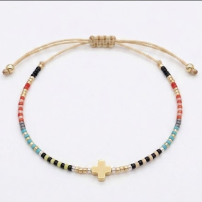 Multicolored beaded bracelet with a gold cross charm on a white background