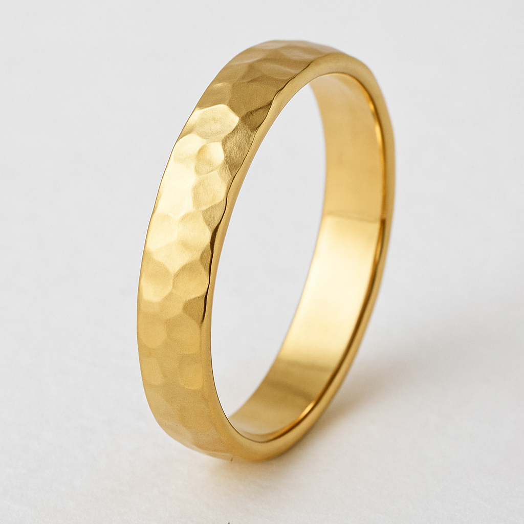 Gold ring with a textured surface on a light gray background