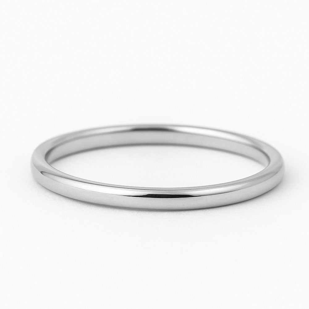 Polished 14K yellow gold thin band on white background-yellow-ring-white-ring