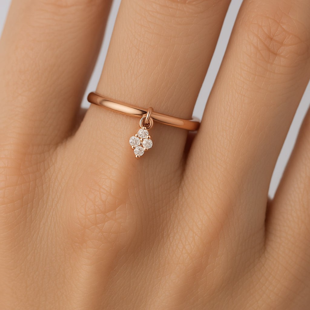 Rose Gold Diamond Charm Ring with a small diamond pendant on a hand against a neutral background
