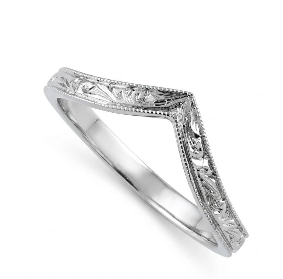 Silver ring with intricate filigree design on a white background