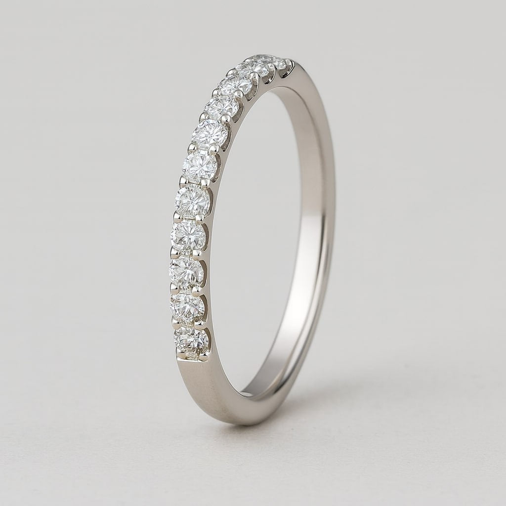 Silver ring with small 11 moissanites on a light gray background