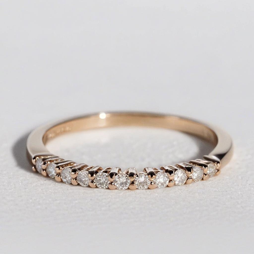 Close-up of a rose gold ring with a thin band. the band is made of rose gold and has a row of small, round diamonds embedded in it. Simple Diamond Dainty Ring