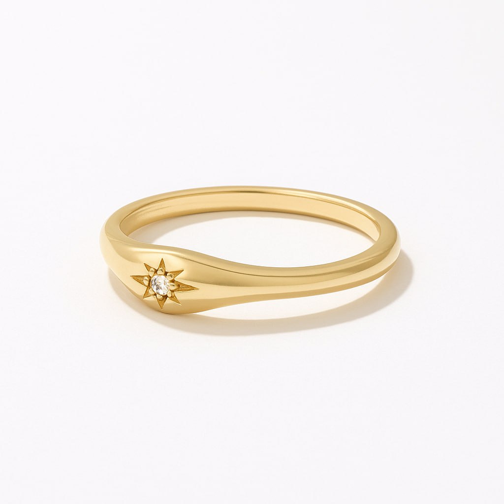 Yellow Gold Star Engraved Ring with a small diamond on a white background
