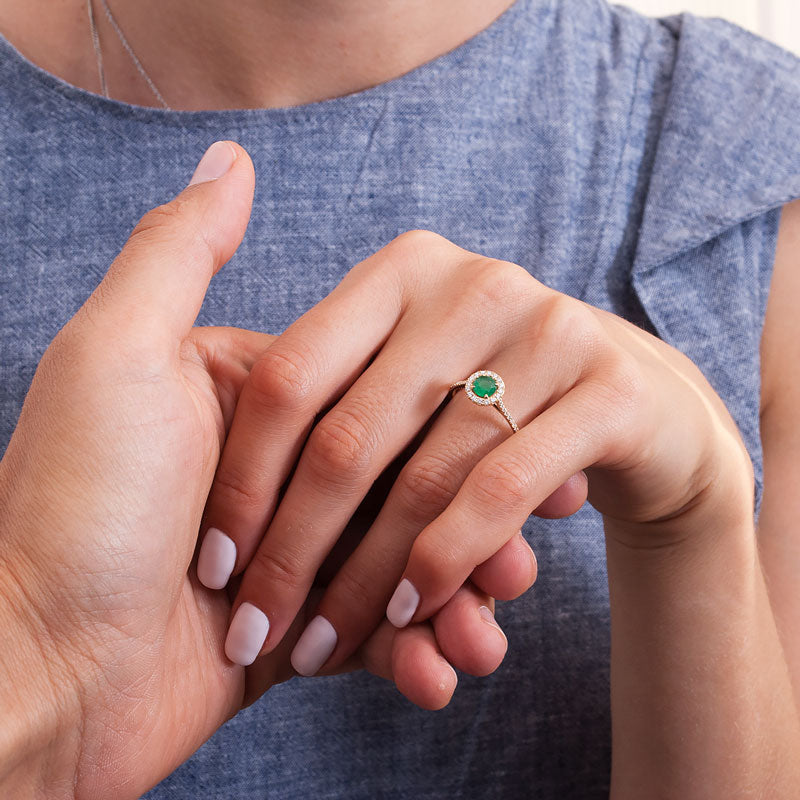 proposal with emerald engagement ring