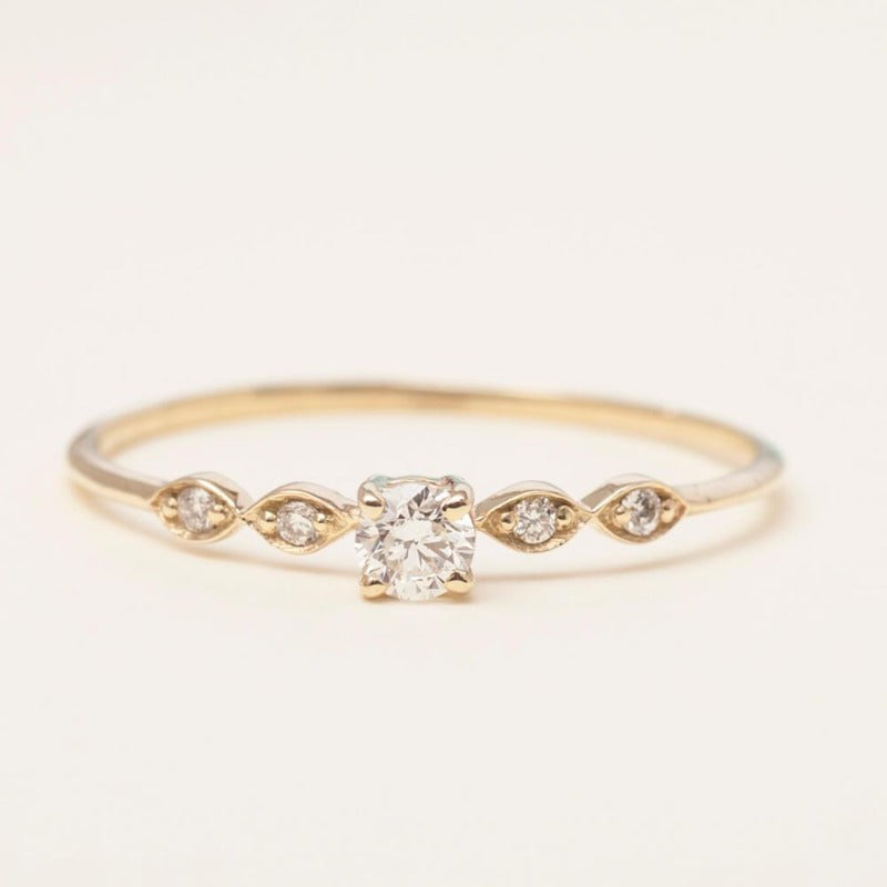 14K white gold pre-engagement ring with round-cut diamond at white background