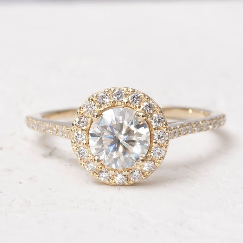 Close-up of 1-carat moissanite halo ring set in 14K yellow gold​1