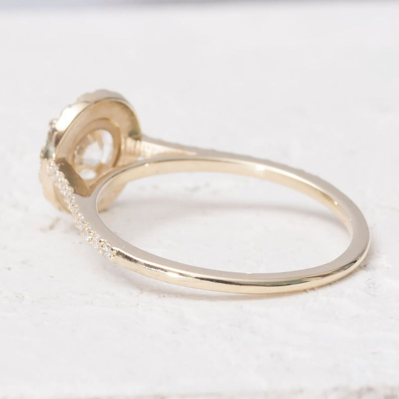 Close-up of 1-carat moissanite halo ring set in 14K yellow gold​  back view