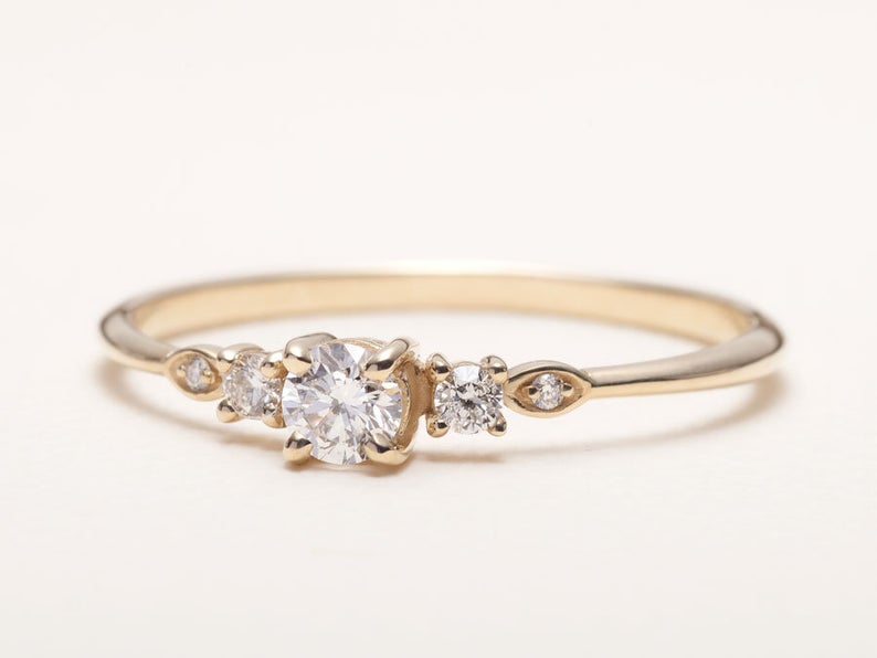 Dainty round-cut diamond set in slim 14K gold band