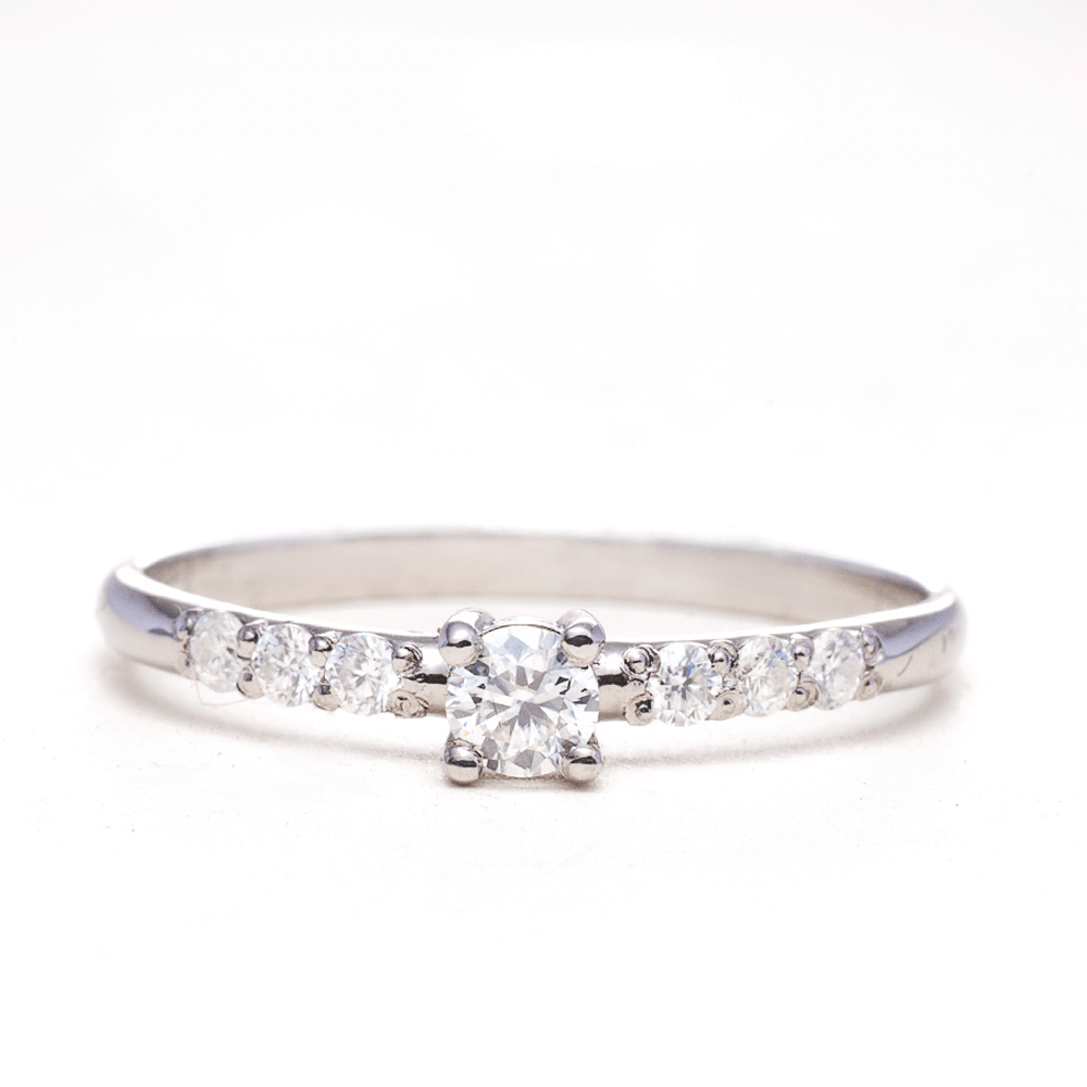 Dainty silver moissanite promise ring with 925 sterling silver band on white background