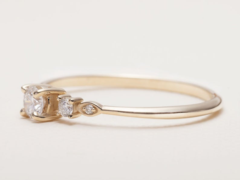 Ultra-thin 14K gold band with subtle diamond detail